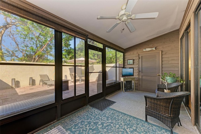 sunroom with ceiling fan and lofted ceiling