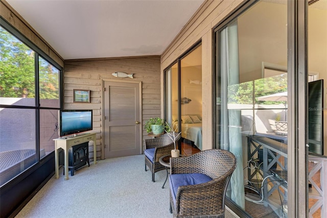 sunroom / solarium featuring vaulted ceiling