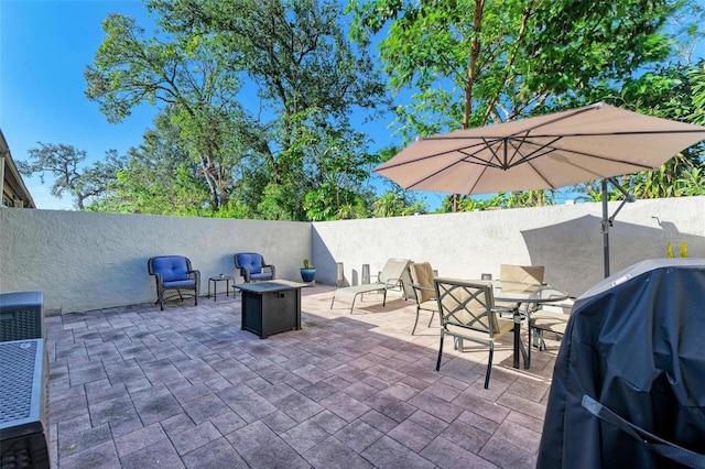 view of patio with a fire pit and area for grilling