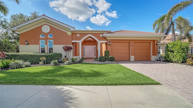 view of front of house with a garage and a front lawn