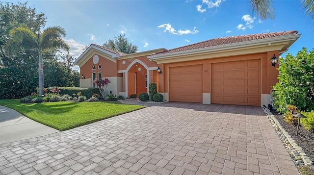 view of front of home with a garage and a front lawn