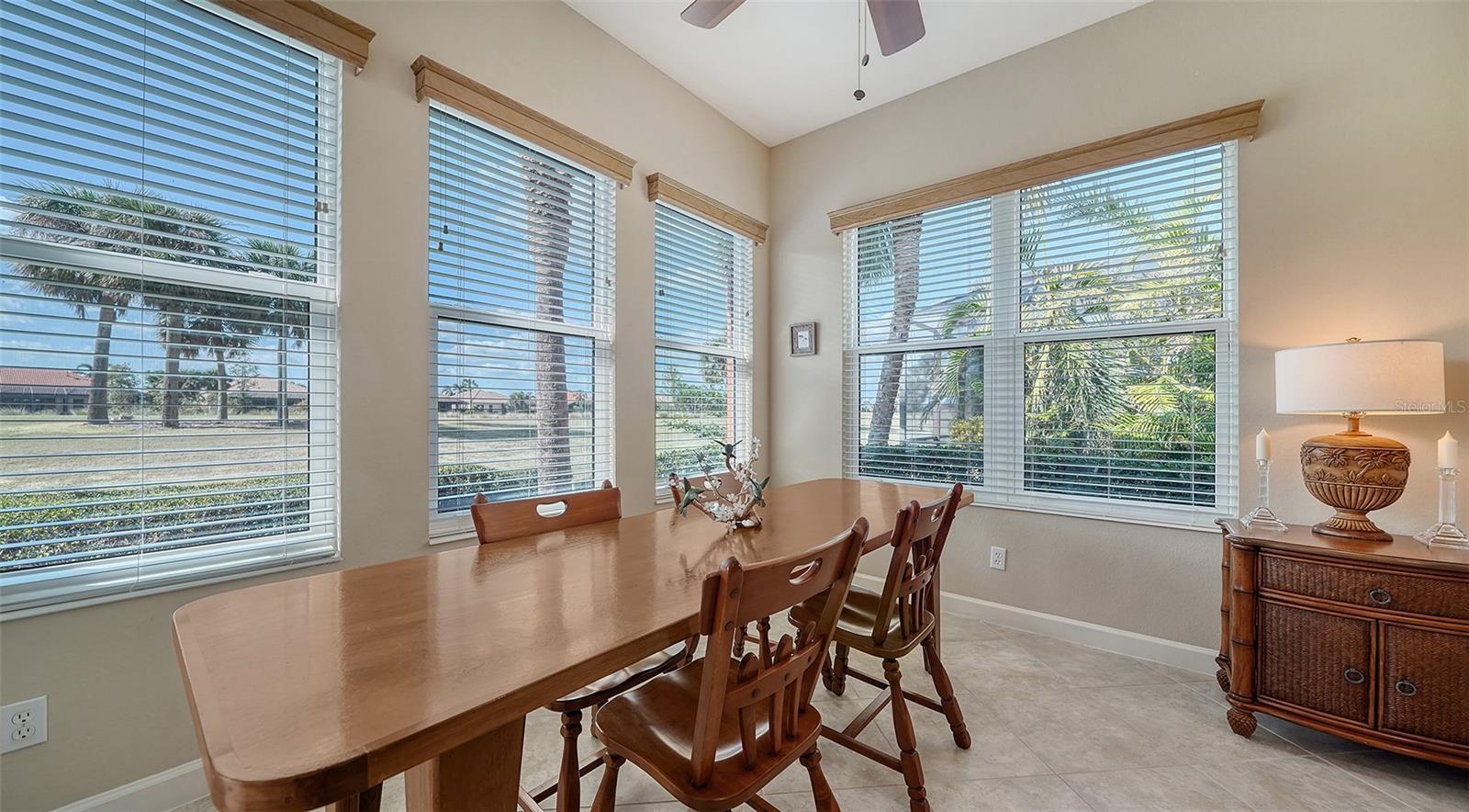 dining area with ceiling fan, light tile patterned flooring, and a wealth of natural light