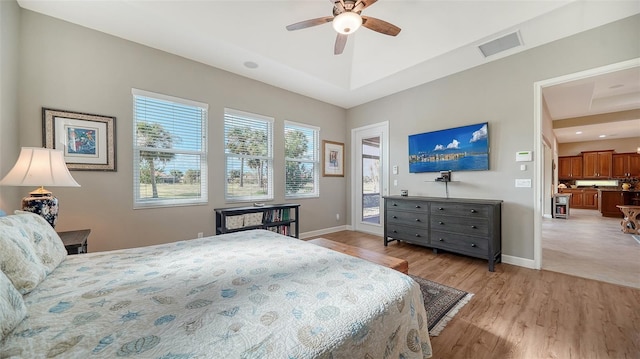 bedroom with access to exterior, light hardwood / wood-style floors, and ceiling fan