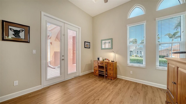 doorway featuring vaulted ceiling, french doors, and light hardwood / wood-style flooring