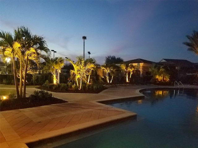 view of pool at dusk