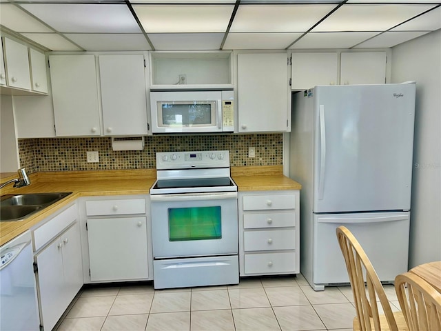 kitchen with sink, white cabinets, white appliances, and light tile patterned floors