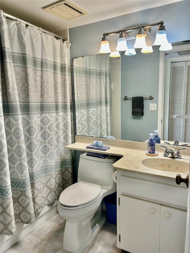 bathroom with tile patterned flooring, vanity, and toilet