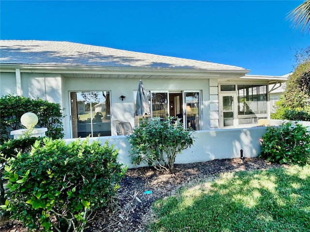 view of side of property with a sunroom