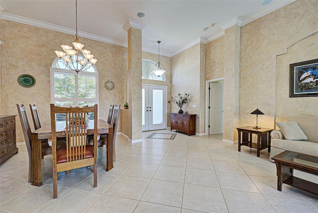 tiled dining area with ornate columns, french doors, a high ceiling, a chandelier, and crown molding