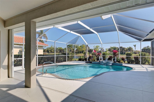 view of pool with an in ground hot tub, glass enclosure, and a patio