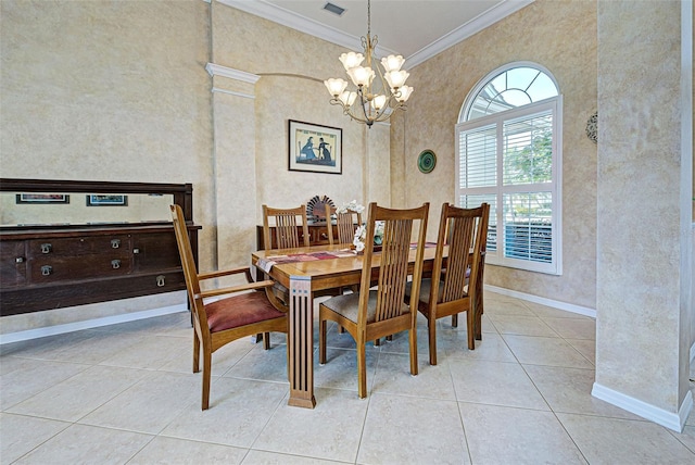 tiled dining area featuring crown molding and a chandelier