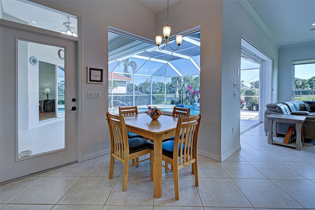 dining area featuring ceiling fan with notable chandelier, light tile patterned flooring, and crown molding