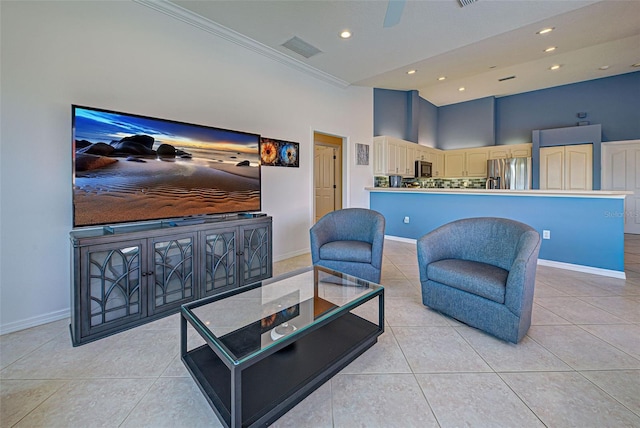 living room featuring a high ceiling, crown molding, ceiling fan, and light tile patterned floors