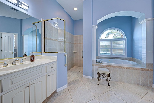 bathroom with lofted ceiling, vanity, tile patterned floors, and separate shower and tub