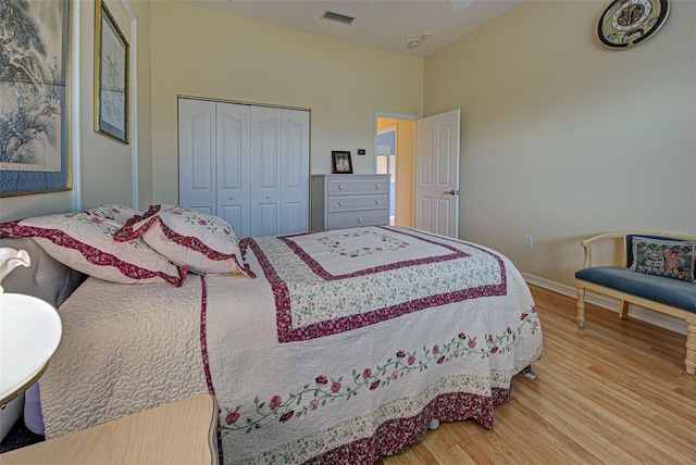 bedroom with a closet and hardwood / wood-style floors