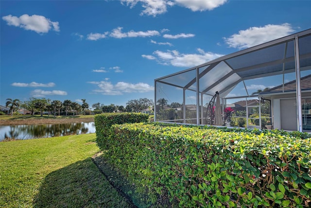 view of yard featuring glass enclosure and a water view