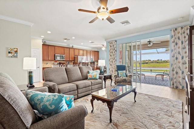 living room featuring crown molding and light wood-type flooring