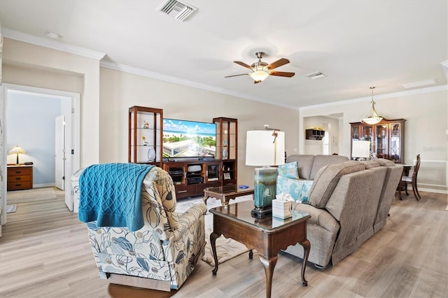 living room featuring ceiling fan, light wood-type flooring, and ornamental molding