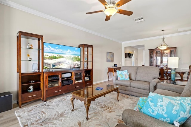 living room with ceiling fan, light wood-type flooring, and crown molding