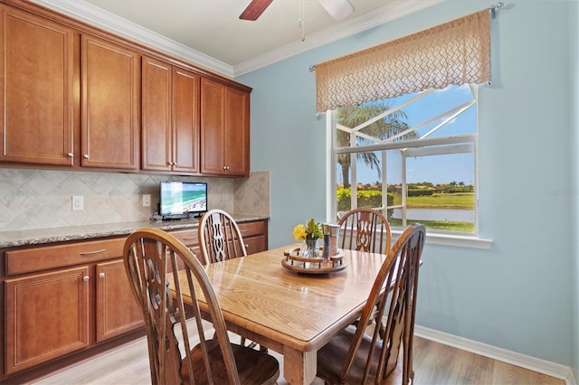 dining space featuring light wood-type flooring, ceiling fan, and crown molding