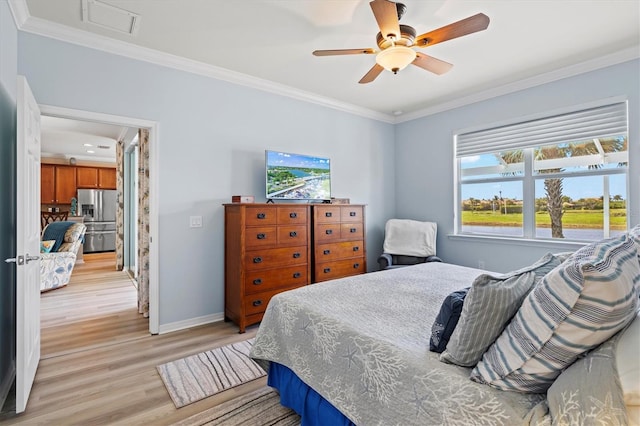 bedroom featuring ceiling fan, light hardwood / wood-style floors, stainless steel refrigerator with ice dispenser, and multiple windows