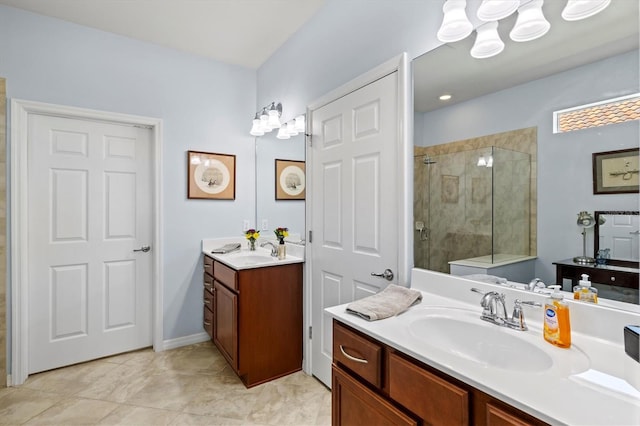 bathroom with tile patterned floors, vanity, and walk in shower