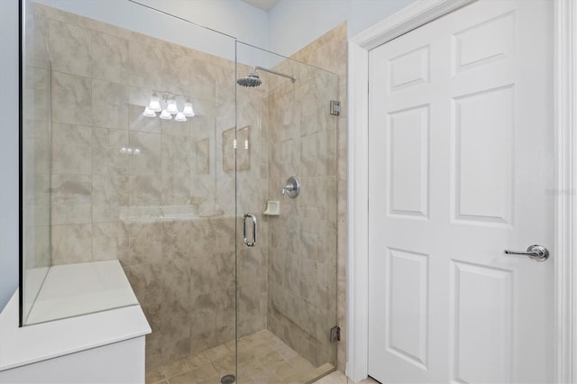 bathroom with a shower with door