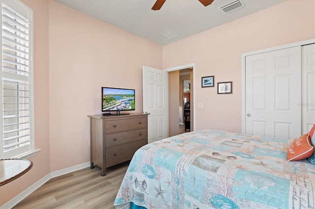 bedroom featuring a closet, light hardwood / wood-style floors, and ceiling fan