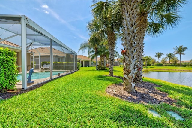 view of yard with a lanai and a water view