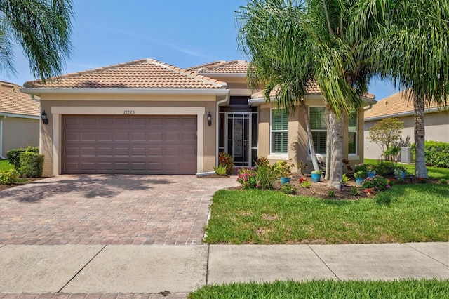 view of front of house with a garage and a front lawn