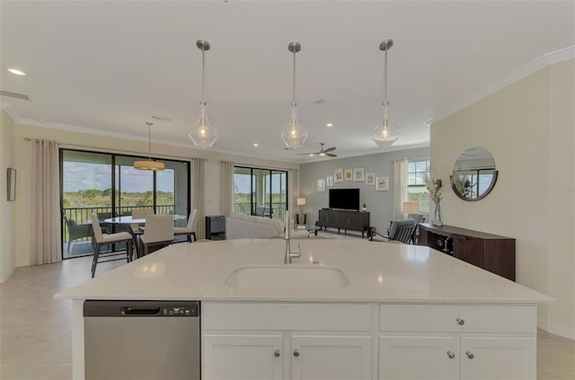 kitchen featuring a wealth of natural light, dishwasher, light stone counters, and sink