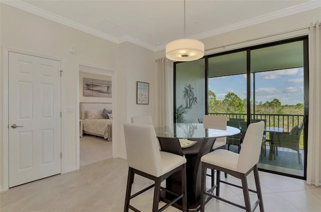 dining room featuring crown molding and light tile patterned flooring