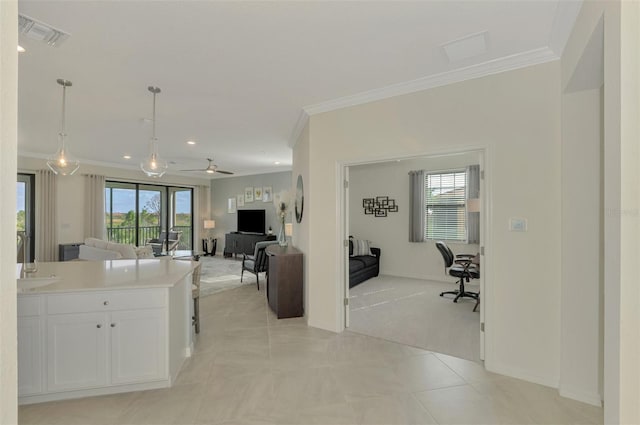 kitchen with white cabinetry, ceiling fan, crown molding, pendant lighting, and light tile patterned floors