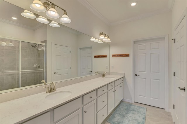 bathroom featuring tile patterned floors, crown molding, vanity, and a shower with shower door