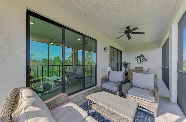 sunroom / solarium featuring ceiling fan