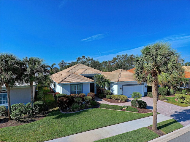 single story home featuring a front yard and a garage