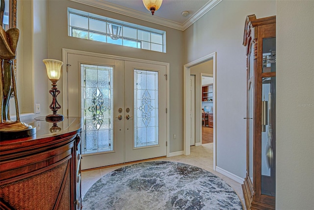 tiled foyer entrance with french doors and ornamental molding