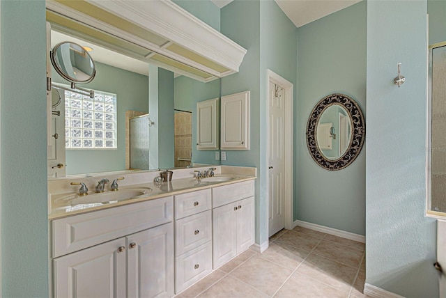 bathroom with tile patterned flooring, vanity, and walk in shower