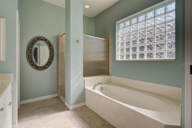 bathroom featuring vanity, tile patterned floors, and separate shower and tub