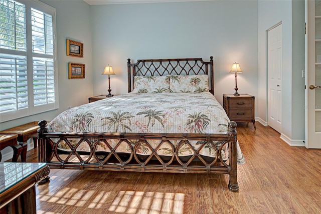 bedroom with hardwood / wood-style flooring and a closet