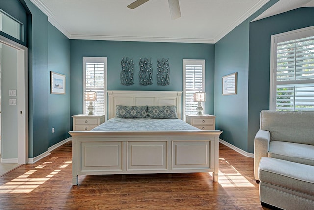 bedroom featuring dark wood-type flooring, ceiling fan, baseboards, and ornamental molding