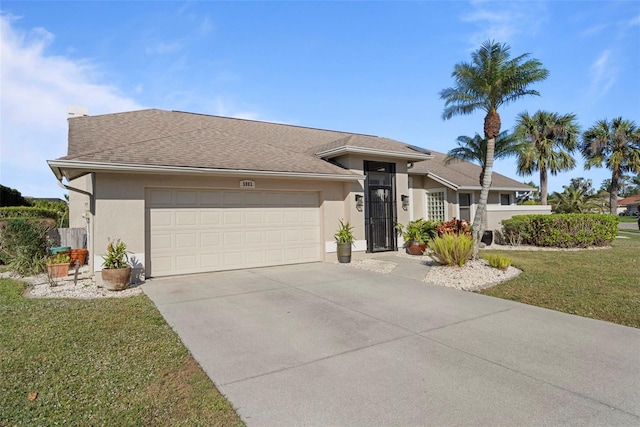 view of front of property with a front yard and a garage