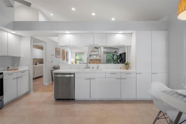 kitchen featuring kitchen peninsula, dishwasher, white cabinets, and sink