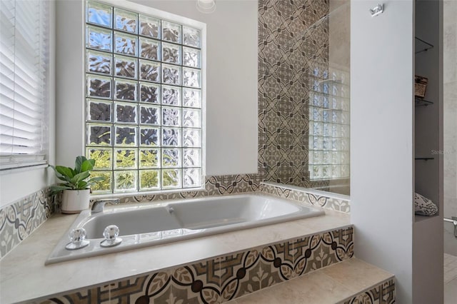 bathroom with a relaxing tiled tub