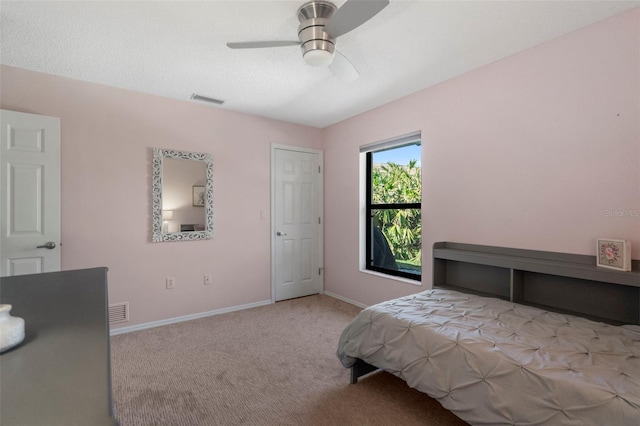 bedroom featuring light colored carpet and ceiling fan