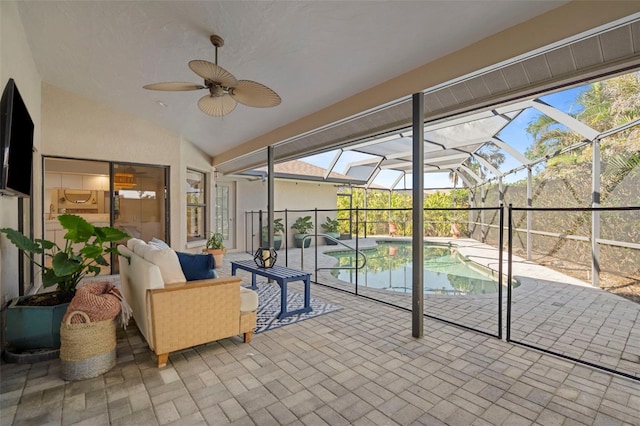 unfurnished sunroom with ceiling fan, a healthy amount of sunlight, and lofted ceiling