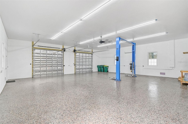 garage with ceiling fan and a garage door opener