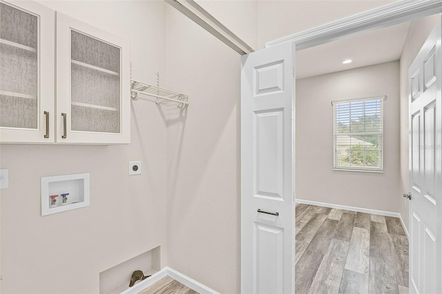 washroom featuring washer hookup, light wood-type flooring, and hookup for an electric dryer