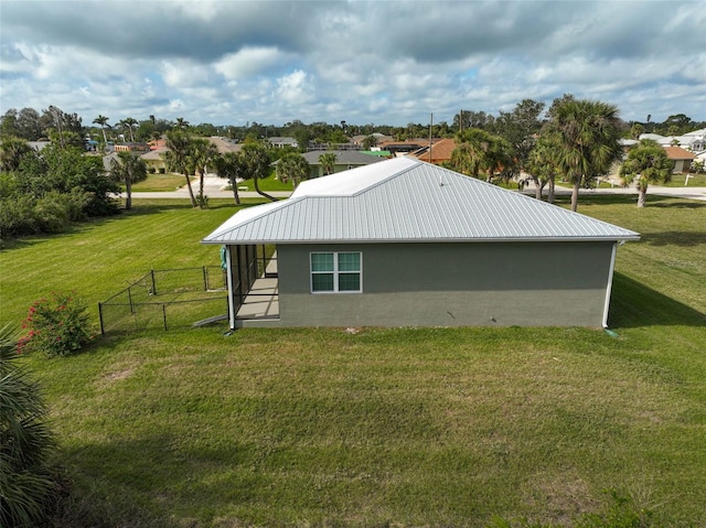 view of side of home with a lawn