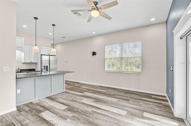 kitchen with light hardwood / wood-style floors, stainless steel fridge, ceiling fan, pendant lighting, and white cabinets